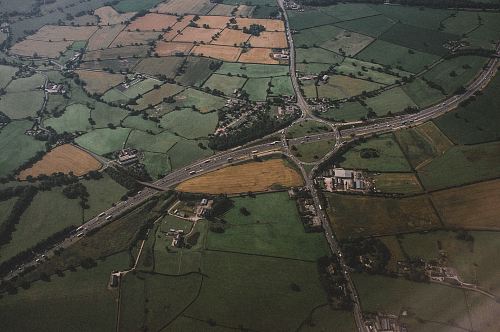 aerial photography of concrete roadway and green field